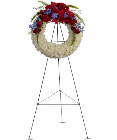 White Wreath with Red Roses & Blue Delphinium
