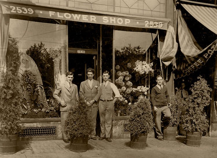 A vintage photo of Thomas Kegan and staff outside the original Blossom Flowers, circa 1925